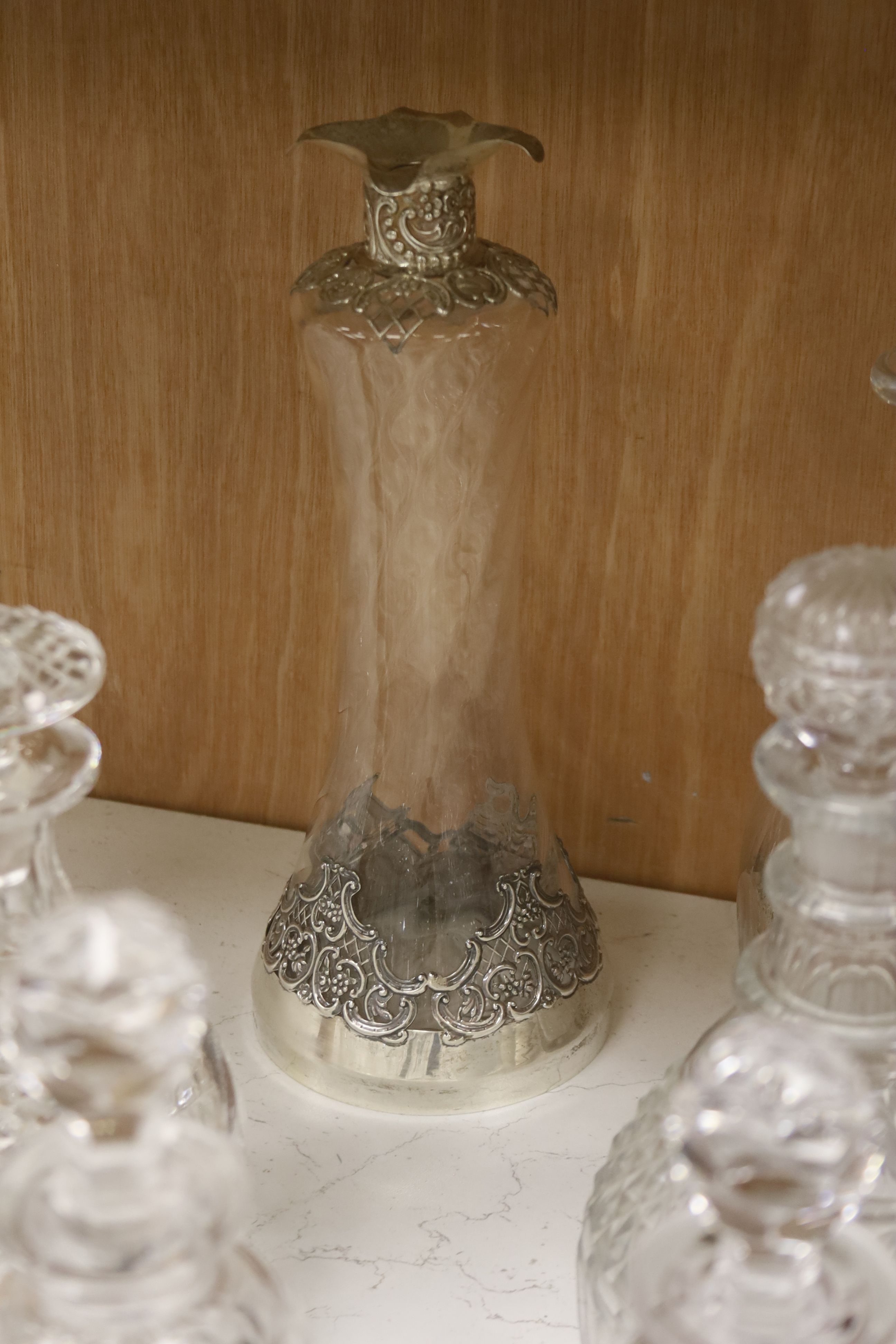 A cut glass punch bowl and a collection of table glassware, to include a late Victorian silver mounted decanter (lacking stopper)